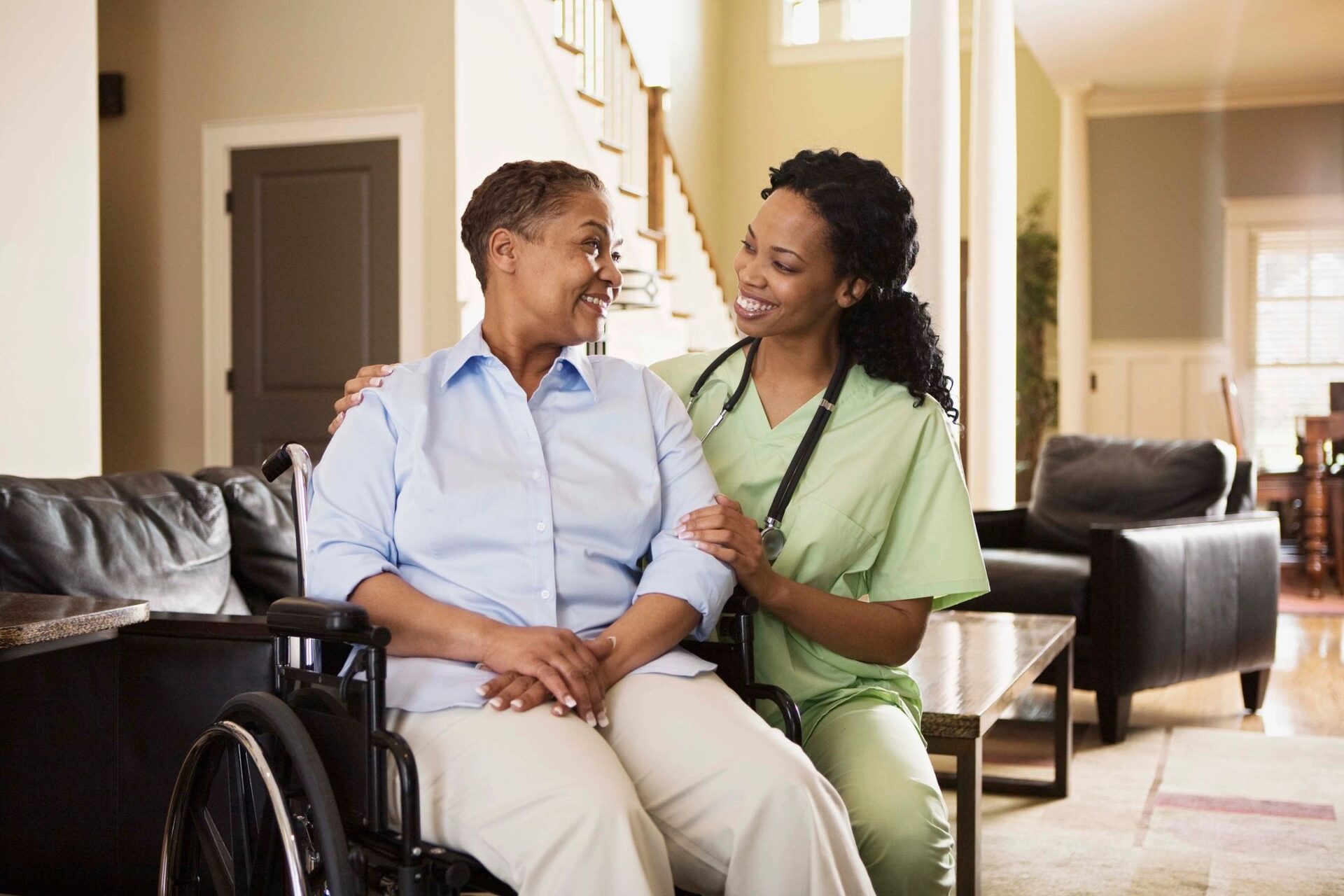 a nurse helping an old woman in a wheelchair